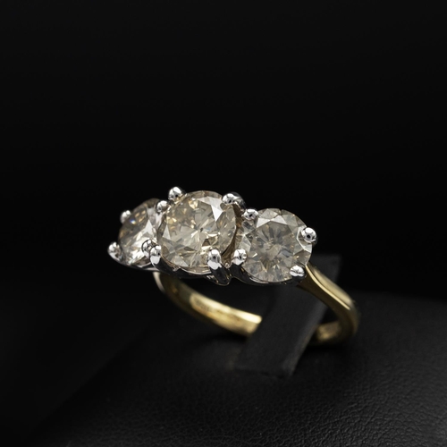 143 - AN 18CT GOLD DIAMOND TRILOGY RING, the white gold open backed setting with three claw set round bril... 