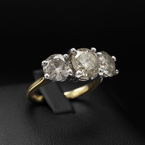 143 - AN 18CT GOLD DIAMOND TRILOGY RING, the white gold open backed setting with three claw set round bril... 