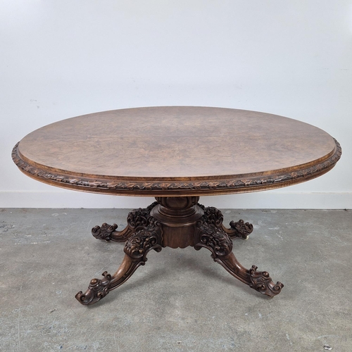 299 - LOO TABLE, Victorian walnut, circa 1850, quarter veneered burr top with leaf carved frieze raised on... 