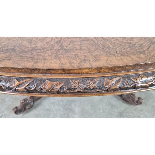 299 - LOO TABLE, Victorian walnut, circa 1850, quarter veneered burr top with leaf carved frieze raised on... 