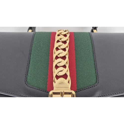 3 - GUCCI SYLVIE BAG, black leather with iconic web stripes and gold tone chain detailing on front flap,... 