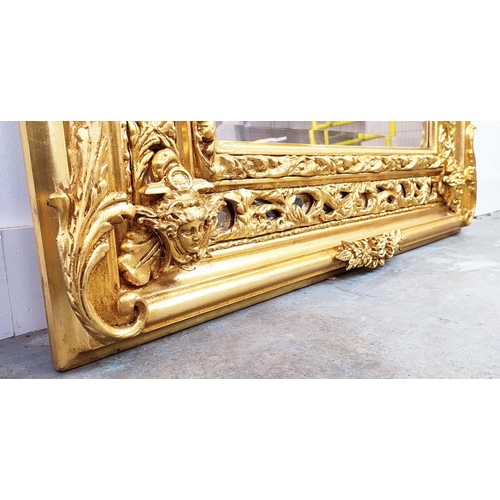 352 - OVERMANTEL, bevelled plate within ornate gilt arched frame, 195cm H x 108cm W.