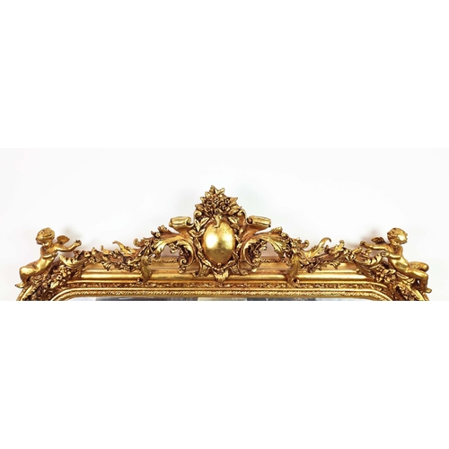 353 - OVERMANTEL, bevelled plate within ornate gilt frame with cherubs, 140cm H x 116cm W.