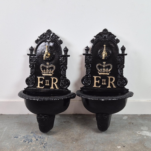 382 - WALL FOUNTAINS, a pair, black painted cast metal, 68cm H x 42cm W. (2)