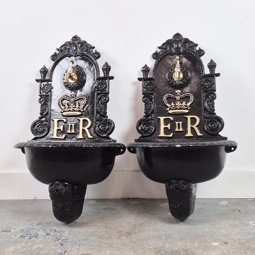 382 - WALL FOUNTAINS, a pair, black painted cast metal, 68cm H x 42cm W. (2)