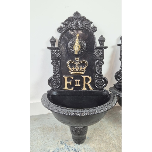 382 - WALL FOUNTAINS, a pair, black painted cast metal, 68cm H x 42cm W. (2)