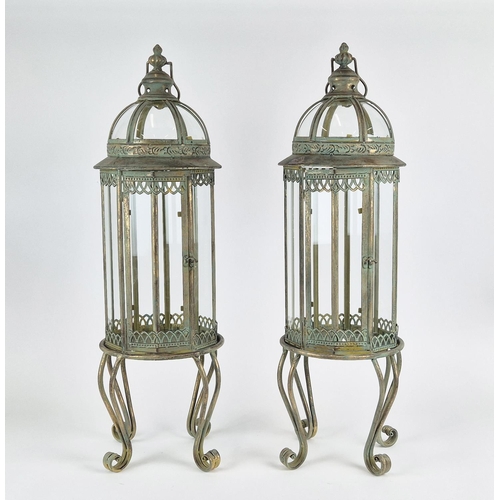 416 - STORM LANTERNS, a pair, faux verdigris finish metal, raised on feet. (2)