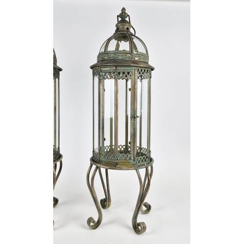 416 - STORM LANTERNS, a pair, faux verdigris finish metal, raised on feet. (2)