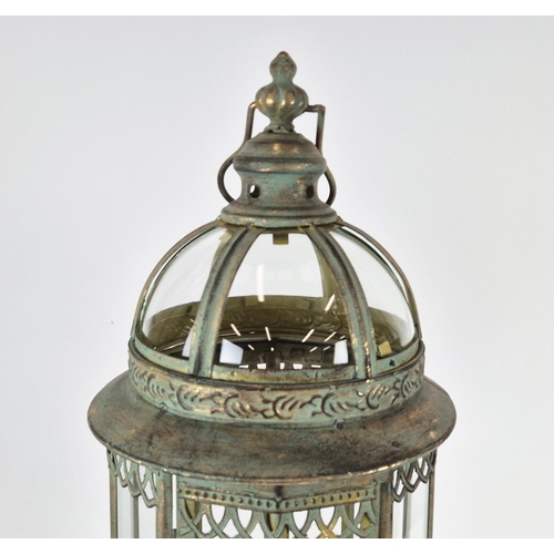 416 - STORM LANTERNS, a pair, faux verdigris finish metal, raised on feet. (2)