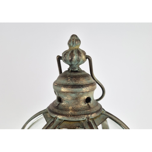 416 - STORM LANTERNS, a pair, faux verdigris finish metal, raised on feet. (2)