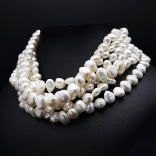 60 - A SIX SRAND FRESHWATER PEARL CHOKER NECKLACE, fitted with approximately 250 white baroque pearls, 44... 