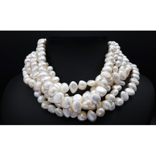 60 - A SIX SRAND FRESHWATER PEARL CHOKER NECKLACE, fitted with approximately 250 white baroque pearls, 44... 