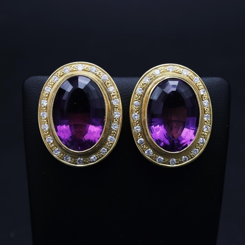 75 - AN 18CT GOLD AMETHYST AND DIAMOND RING AND EARRING SET, the clip-on earrings each set with a large o... 