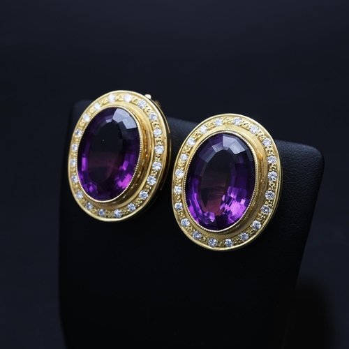 75 - AN 18CT GOLD AMETHYST AND DIAMOND RING AND EARRING SET, the clip-on earrings each set with a large o... 