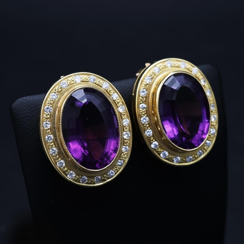 75 - AN 18CT GOLD AMETHYST AND DIAMOND RING AND EARRING SET, the clip-on earrings each set with a large o... 