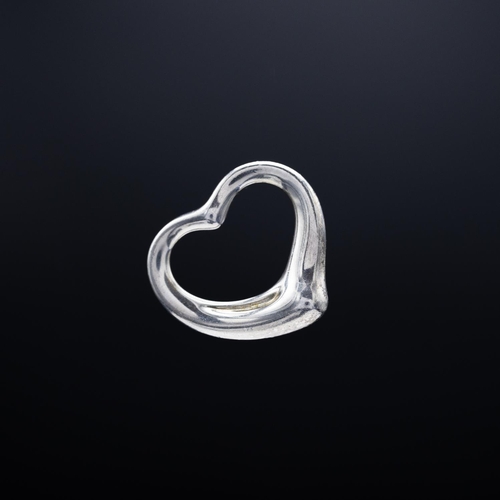 79 - A TIFFANY STERLING SILVER HEART SHAPED PENDANT, a solid heart shaped miniature pendant, a Tiffany ke... 