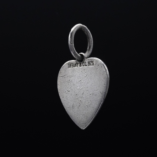 79 - A TIFFANY STERLING SILVER HEART SHAPED PENDANT, a solid heart shaped miniature pendant, a Tiffany ke... 