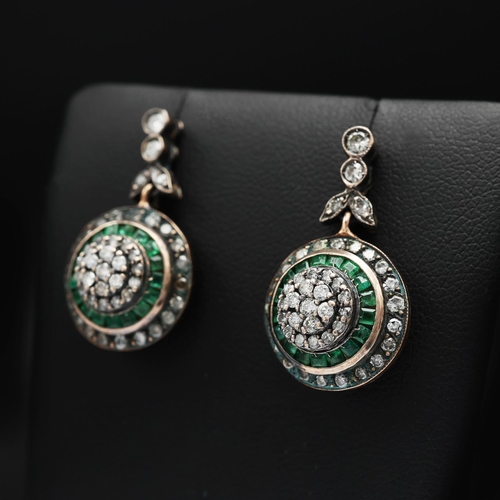 91 - A PAIR OF EMERALD AND DIAMOND PENDANT EARRINGS, rose yellow metal backs, each with a cluster of diam... 