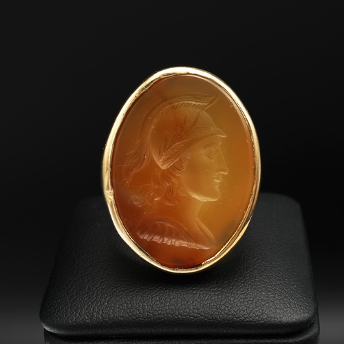 95 - A 9CT GOLD SIGNET RING, set with a carnelian intaglio depicting the profile of a warrior, open backe... 