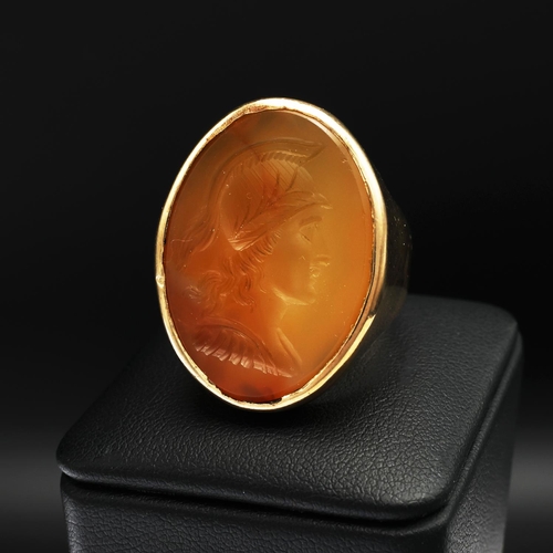 95 - A 9CT GOLD SIGNET RING, set with a carnelian intaglio depicting the profile of a warrior, open backe... 