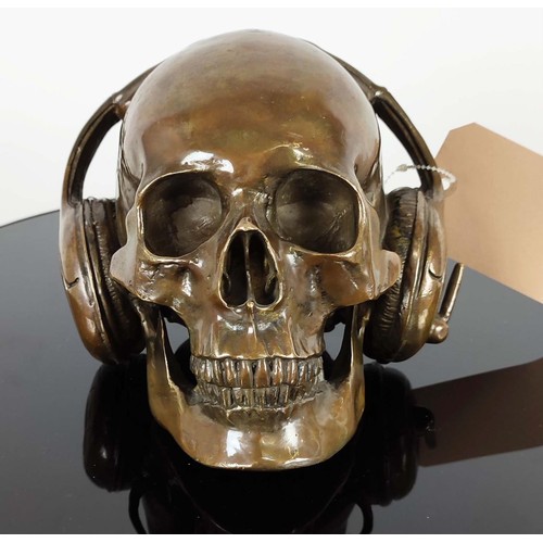 364 - CONTEMPORARY SCHOOL DJ SKULL, cast metal, 18cm H x 18cm W.