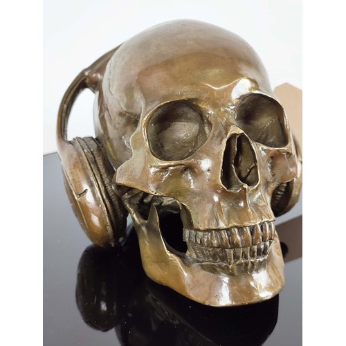 364 - CONTEMPORARY SCHOOL DJ SKULL, cast metal, 18cm H x 18cm W.