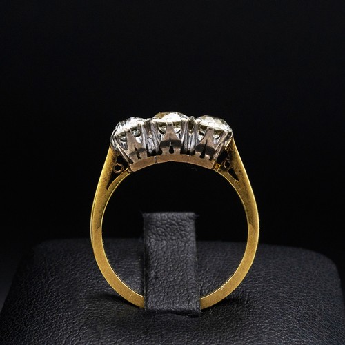 63 - AN 18CT GOLD DIAMOND TRILOGY RING, with three claw set round brilliant diamonds, each of approximate... 