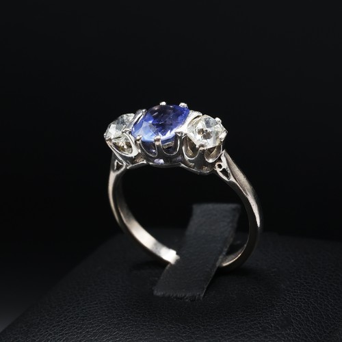 100 - AN 18CT WHITE GOLD CEYLON SAPPHIRE AND DIAMOND TRILOGY RING, the central mixed cut sapphire of appro... 