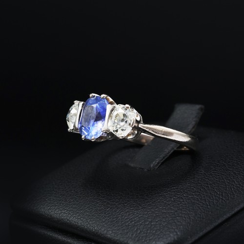 100 - AN 18CT WHITE GOLD CEYLON SAPPHIRE AND DIAMOND TRILOGY RING, the central mixed cut sapphire of appro... 