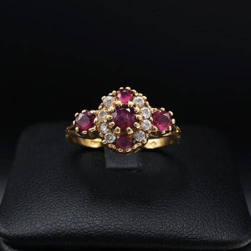 110 - AN 18CT YELLOW GOLD RUBY AND DIAMOND DRESS RING, set with five mixed cut rubies interspaced with eig... 