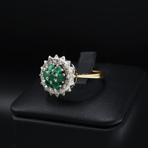 111 - AN 18CT GOLD EMERALD AND DIAMOND DRESS RING, mid 20th century, the platinum open backed setting with... 