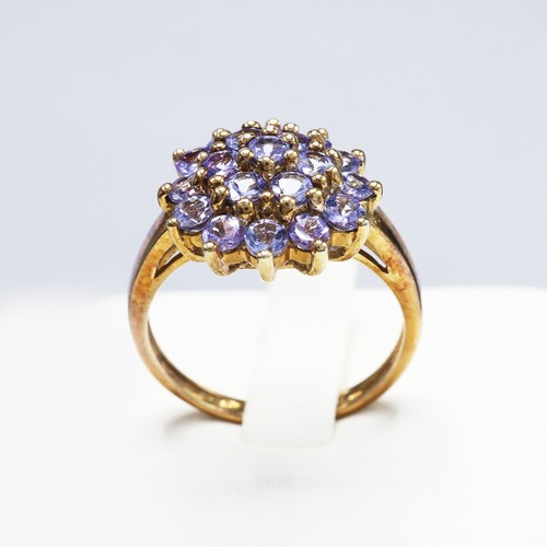 112 - A 9CT GOLD TANZANITE CLUSTER RING, set with 19 round mixed cut tanzanites, ring size K½, together wi... 