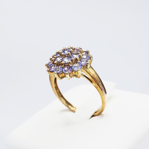 112 - A 9CT GOLD TANZANITE CLUSTER RING, set with 19 round mixed cut tanzanites, ring size K½, together wi... 