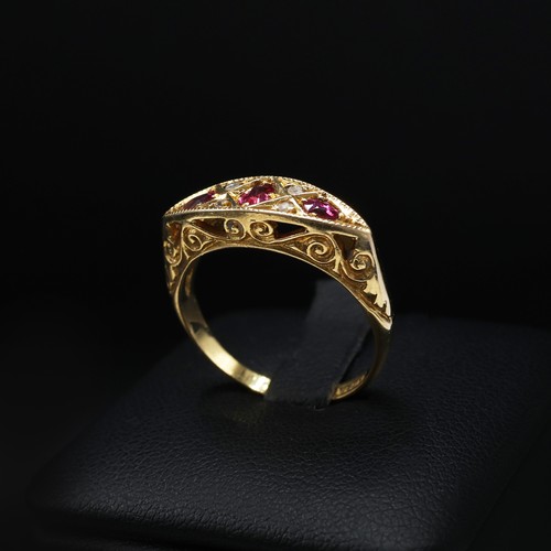 118 - AN 18CT YELLOW GOLD RUBY AND DIAMOND DRESS RING, early 20th century, scrolled mount, open back setti... 