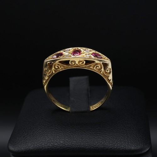 118 - AN 18CT YELLOW GOLD RUBY AND DIAMOND DRESS RING, early 20th century, scrolled mount, open back setti... 