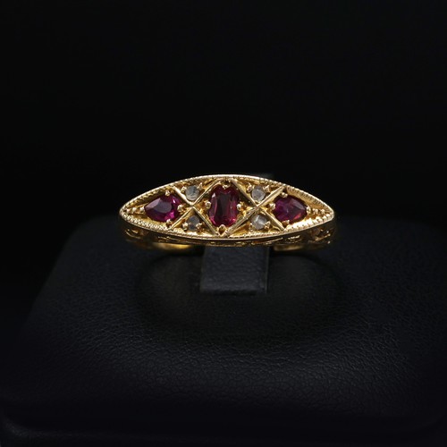 118 - AN 18CT YELLOW GOLD RUBY AND DIAMOND DRESS RING, early 20th century, scrolled mount, open back setti... 