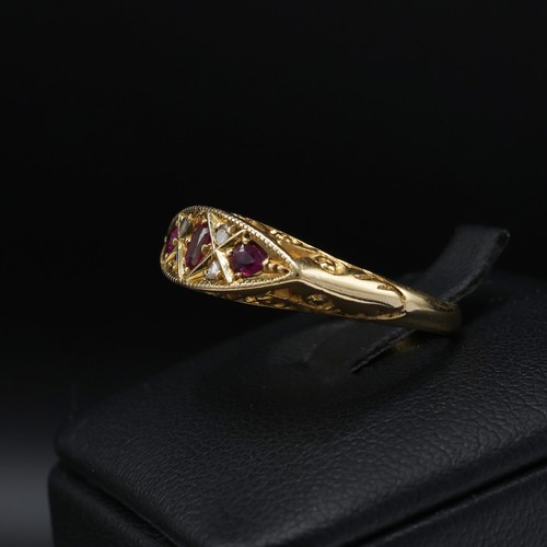 118 - AN 18CT YELLOW GOLD RUBY AND DIAMOND DRESS RING, early 20th century, scrolled mount, open back setti... 