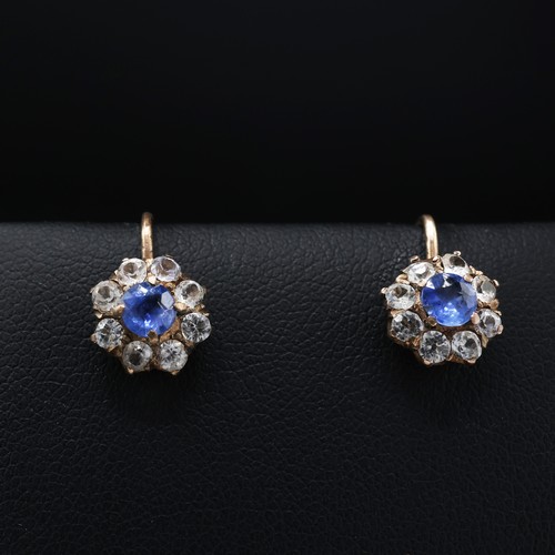 120 - A PAIR OF WHITE AND BLUE SAPPHIRE CLUSTER EARRINGS, each with a central mixed cut sapphire and a hal... 