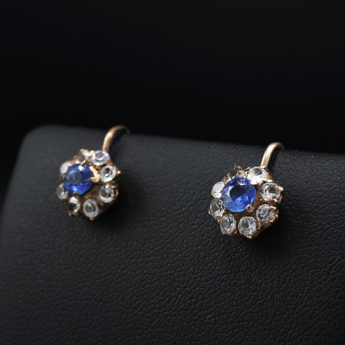 120 - A PAIR OF WHITE AND BLUE SAPPHIRE CLUSTER EARRINGS, each with a central mixed cut sapphire and a hal... 