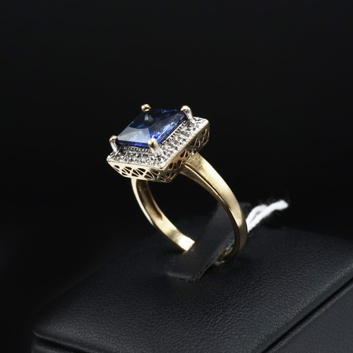 69 - A 9CT GOLD SAPPHIRE AND DIAMOND SET DRESS RING, the central square cut sapphire with a marcasite sur... 