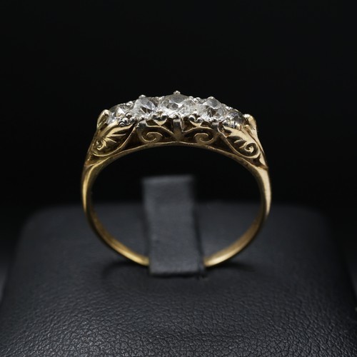 109 - A YELLOW METAL FIVE STONE DIAMOND DRESS RING, set with five graduated brilliant cut diamonds with a ... 