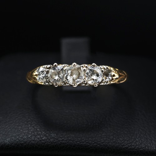 109 - A YELLOW METAL FIVE STONE DIAMOND DRESS RING, set with five graduated brilliant cut diamonds with a ... 