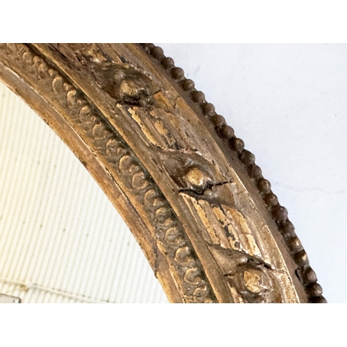 547 - WALL MIRROR, 19th century giltwood and gesso with oval beaded frame with foliate crest and base, 81c... 