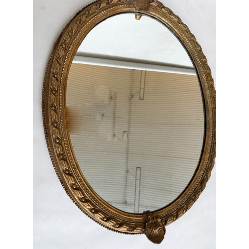 547 - WALL MIRROR, 19th century giltwood and gesso with oval beaded frame with foliate crest and base, 81c... 