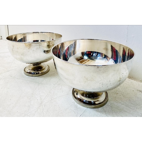 315 - PUNCH BOWLS, a pair, Regency style, polished metal. (2)