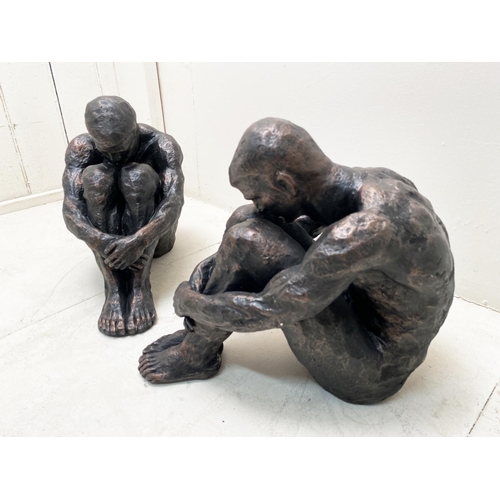 318 - CONTEMPORARY SITTING MAN SCULPTURES, a pair, resin, 34cm H x 21cm W x 40cm D. (2)