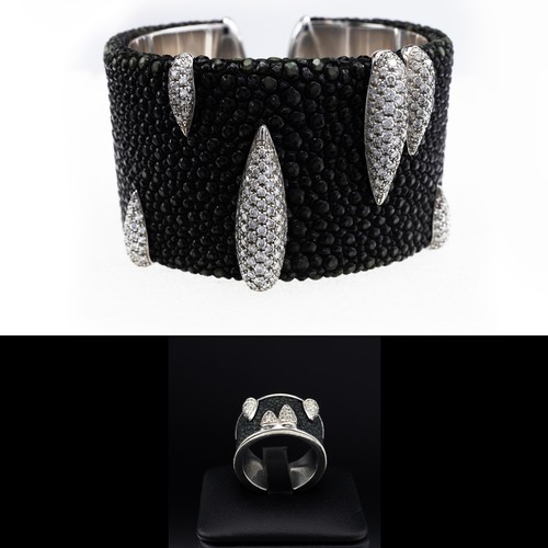 84 - AN 18CT WHITE GOLD SHAGREEN AND DIAMOND ENCRUSTED CUFF BANGLE, with torpedo shaped motifs encrusted ... 