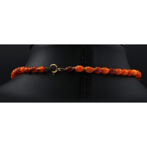 108 - AN AMBER SINGLE STRAND BEAD NECKLACE, fitted with approximately 50 graduated oval shaped amber beads... 