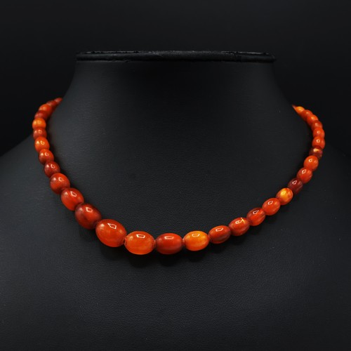 108 - AN AMBER SINGLE STRAND BEAD NECKLACE, fitted with approximately 50 graduated oval shaped amber beads... 