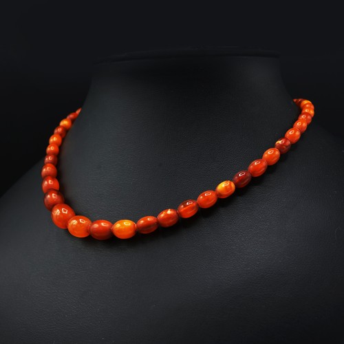 108 - AN AMBER SINGLE STRAND BEAD NECKLACE, fitted with approximately 50 graduated oval shaped amber beads... 